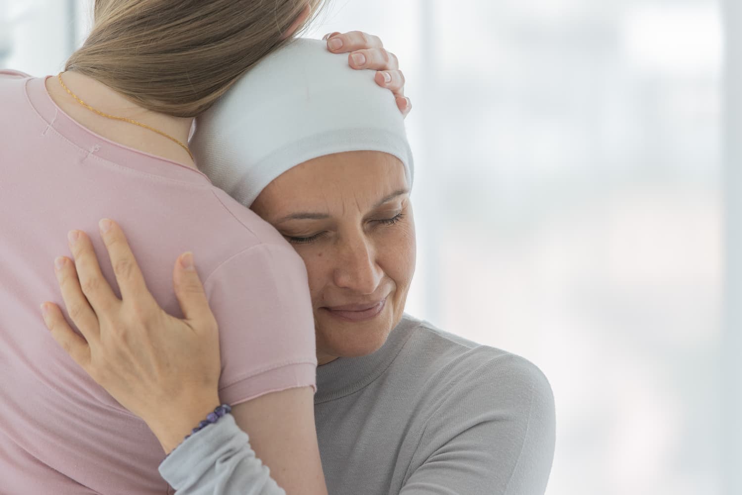 49. A middle-aged breast cancer woman hug and cuddle her daughter (1)